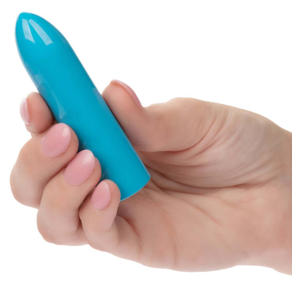 Hand holding Turbo Buzz Classic Bullet - Blue compact stimulator with 10 vibration functions.