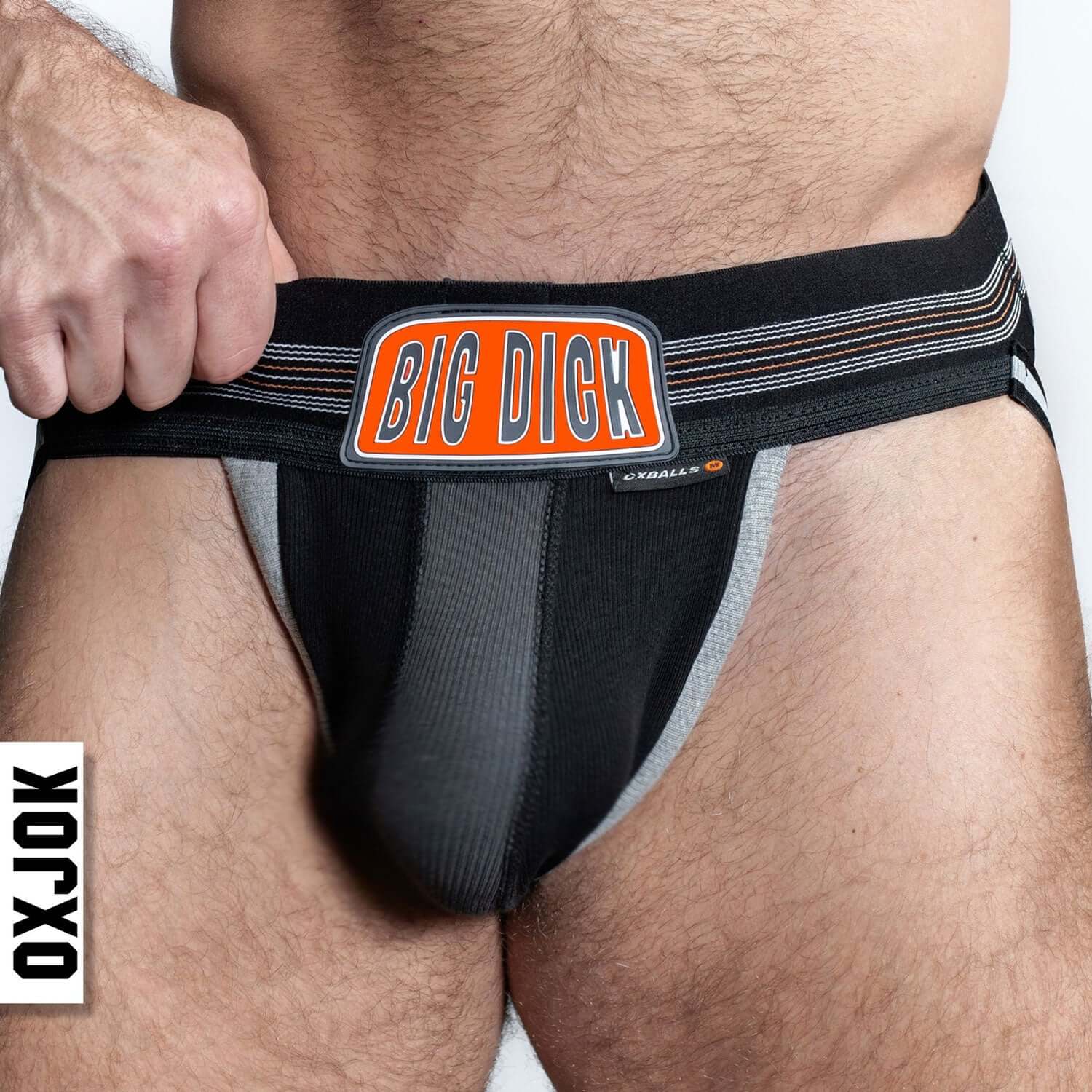 Man wearing Bulger the Big Pouch Jock Black Iron XL from OXJOK with "Big Dick" label on waistband.