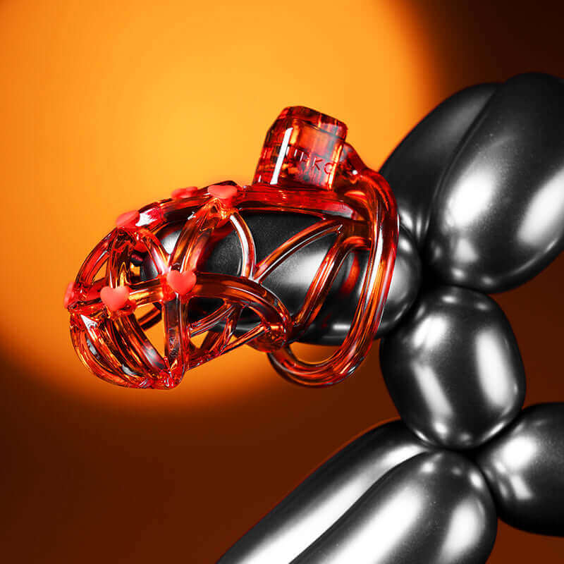 UPKO Caged Beast male chastity device kit in orange, showcasing unique 3D design and artistic aesthetics against a dramatic background.