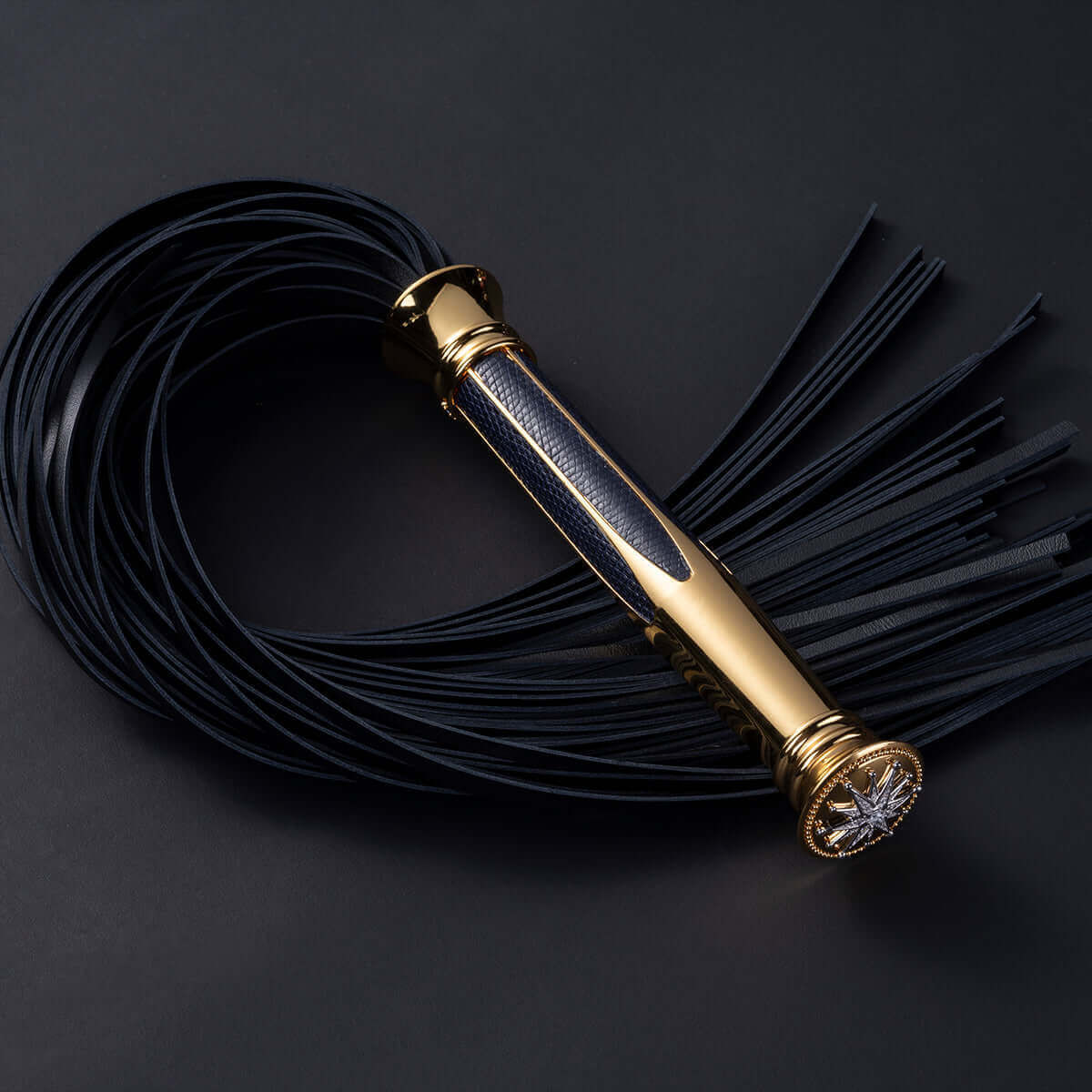 UPKO Black Label Collection Flogger in black leather with gold handle and elegant design, symbolizing intimate connections.