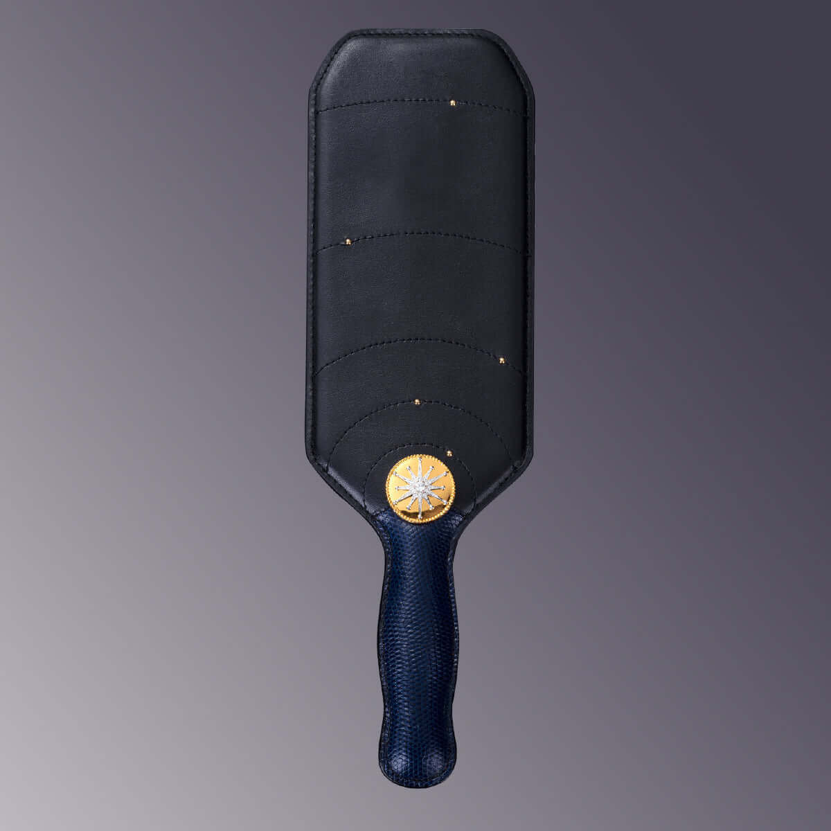 UPKO Black Label Collection paddle featuring Italian leather and a gold emblem, symbolizing luxury and elegance.