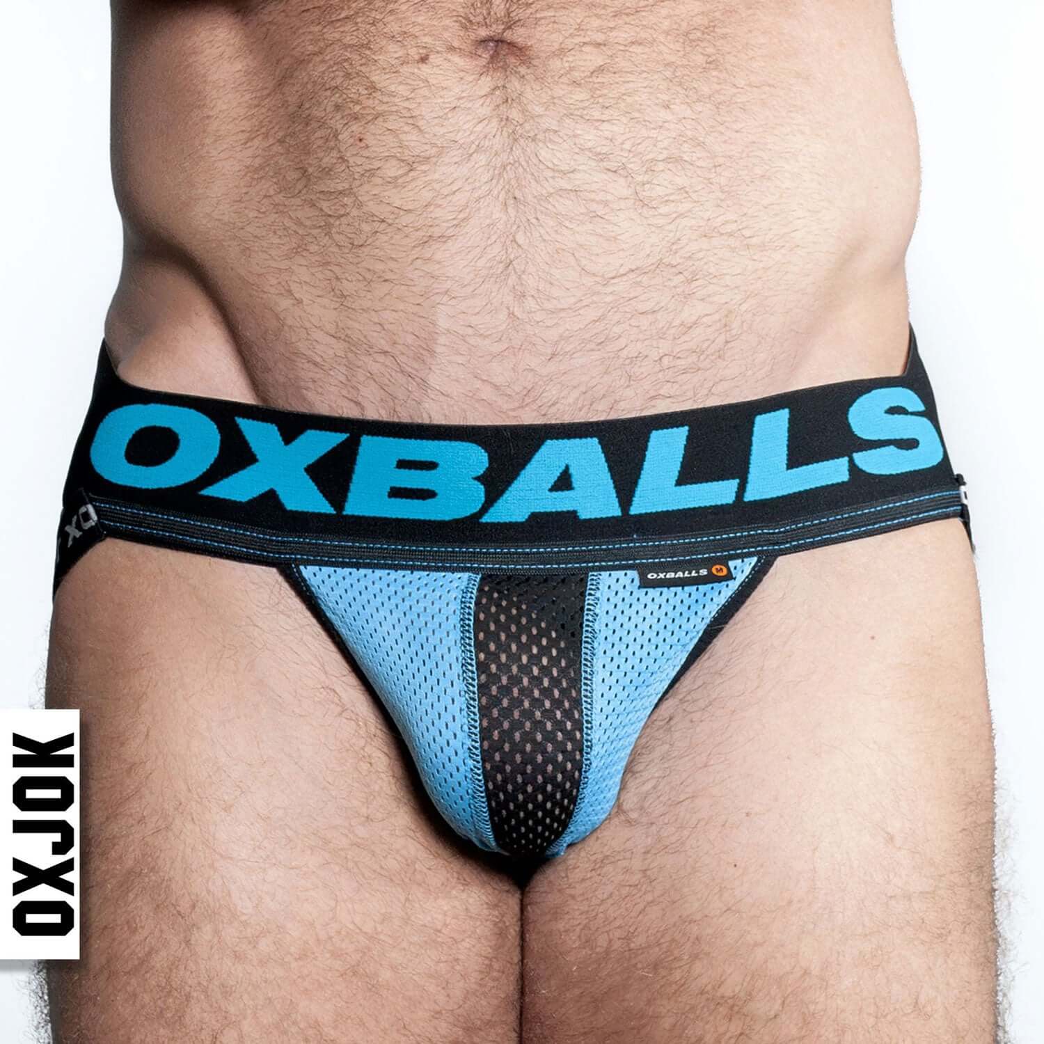 Man wearing Airmesh Upthrust Slider-Strap Jock Sky Blue XL by Oxballs, featuring breathable mesh and supportive waistband.