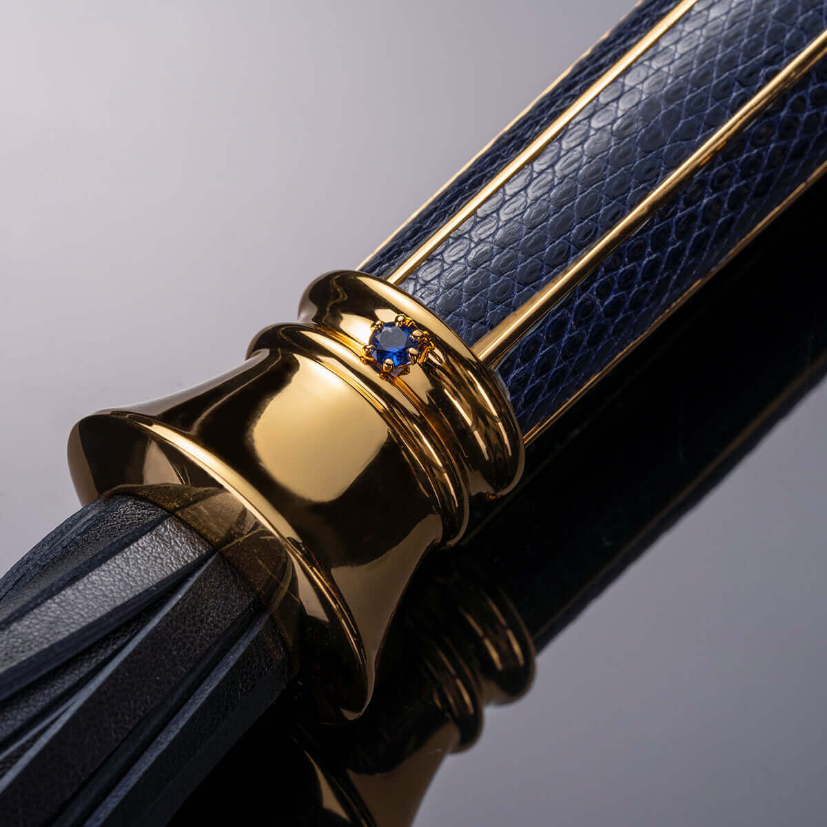 UPKO Black Label Collection Flogger featuring luxurious Italian leather and a gold-plated handle with a blue stone accent.