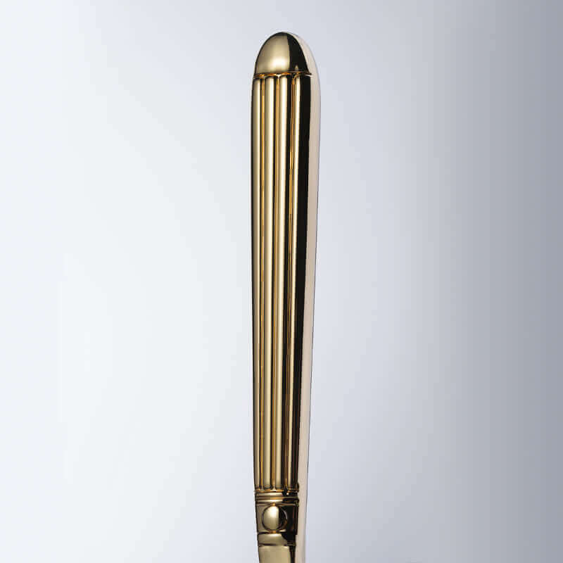 Elegant gold handle of a stylish accessory, showcasing smooth lines and polished finish for a luxurious look.