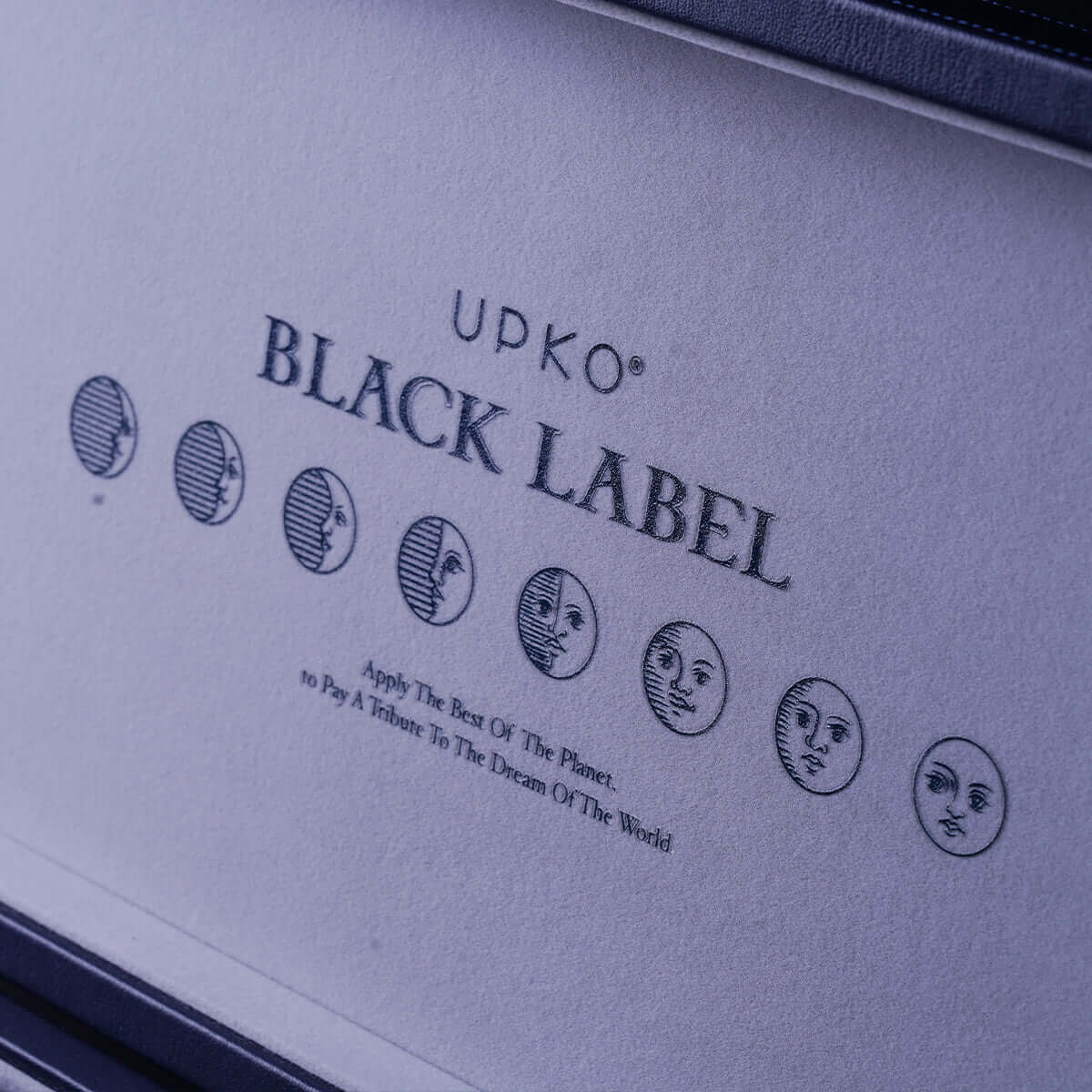 UPKO Black Label logo with elegant graphics displayed on soft interior fabric of a deluxe storage case.