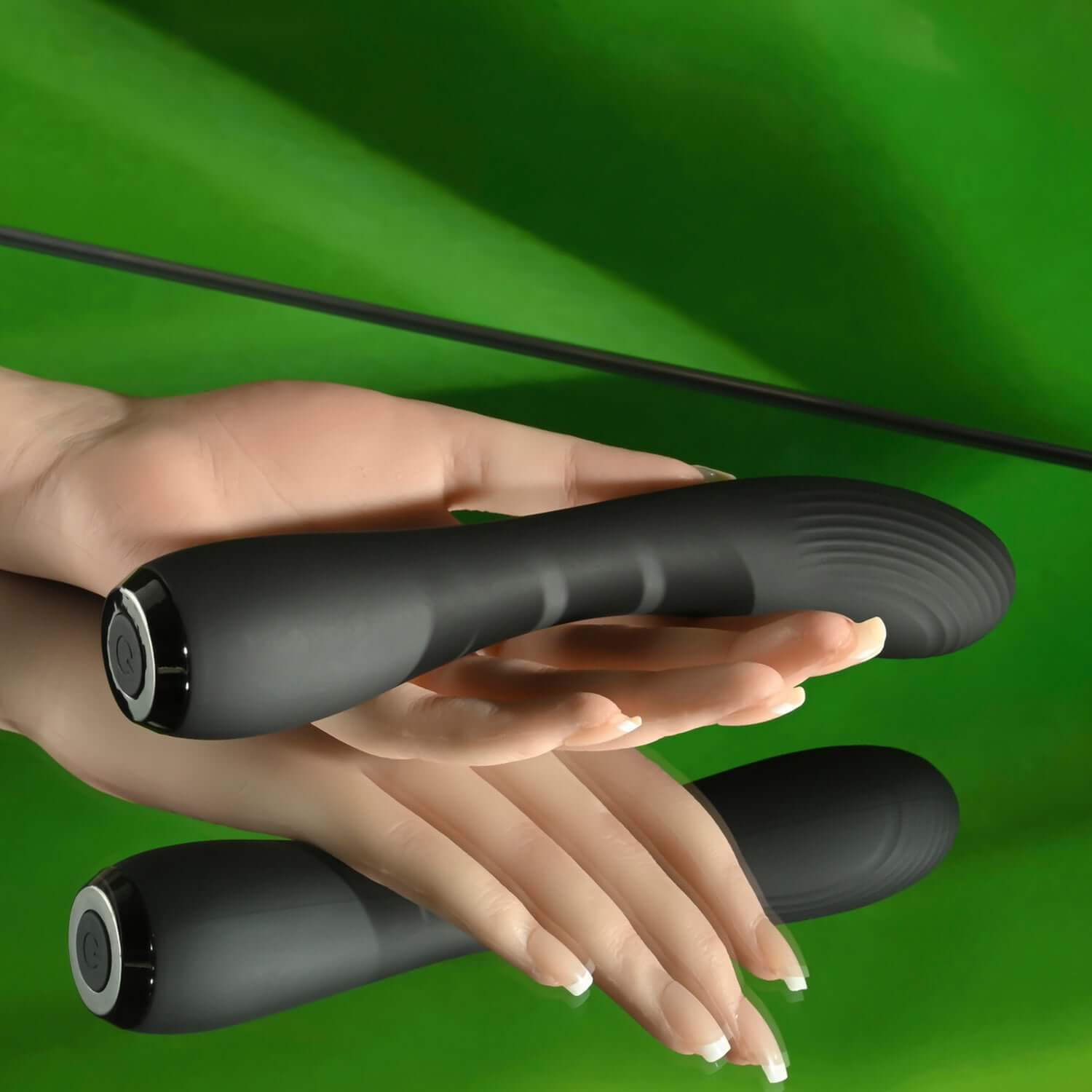 Midnight Magic G-spot vibrator in black resting on a hand, showcasing its sleek design against a green background.