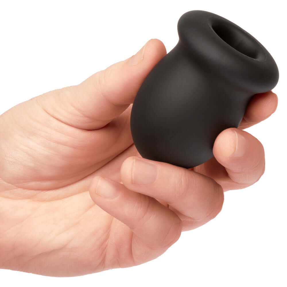 Hand holding the Boundless FTM Stroker 2.75 Inch in black, made from soft liquid silicone for enhanced pleasure and durability.