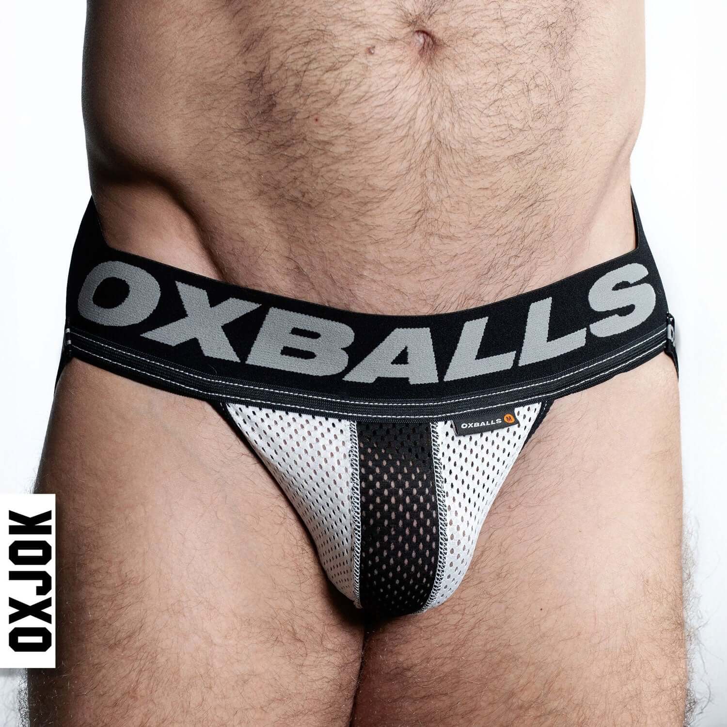 Man wearing Airmesh Upthrust Slider-Strap Jock in Ice White by Oxballs with supportive tri-fold pouch and bold waistband optimization.