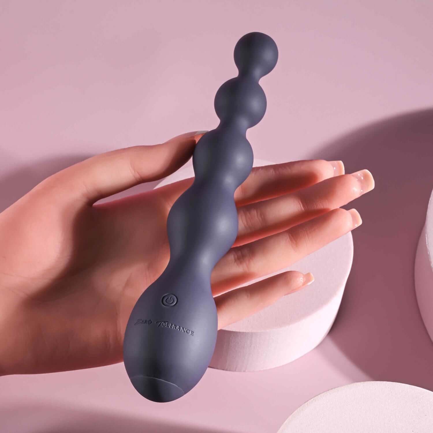 Rumpy Bumpy Anal Vibrator in hand, showcasing its flexible shaft and graduated bulbs for enhanced pleasure.