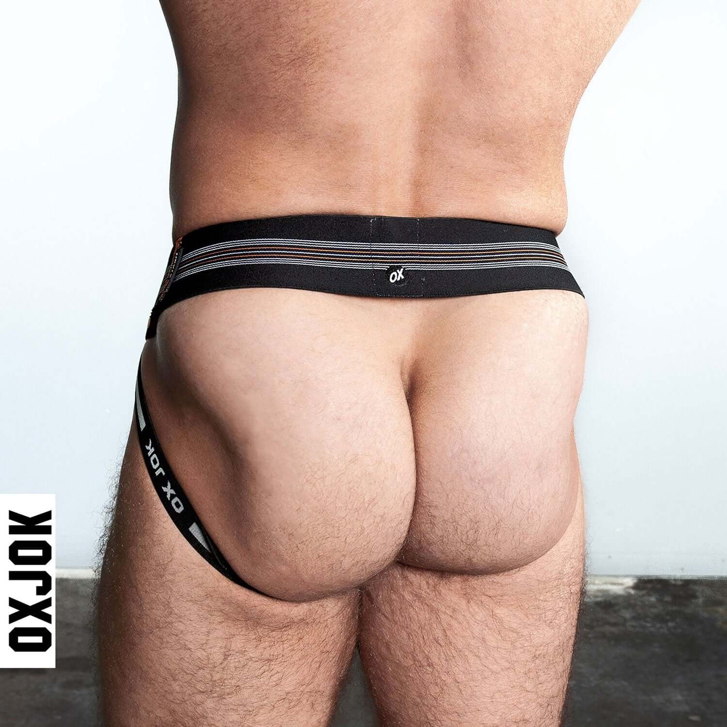 Man wearing Slingjock Upthrust Slider-Strap Jock in Black Iron for optimal comfort and support by Oxjok.