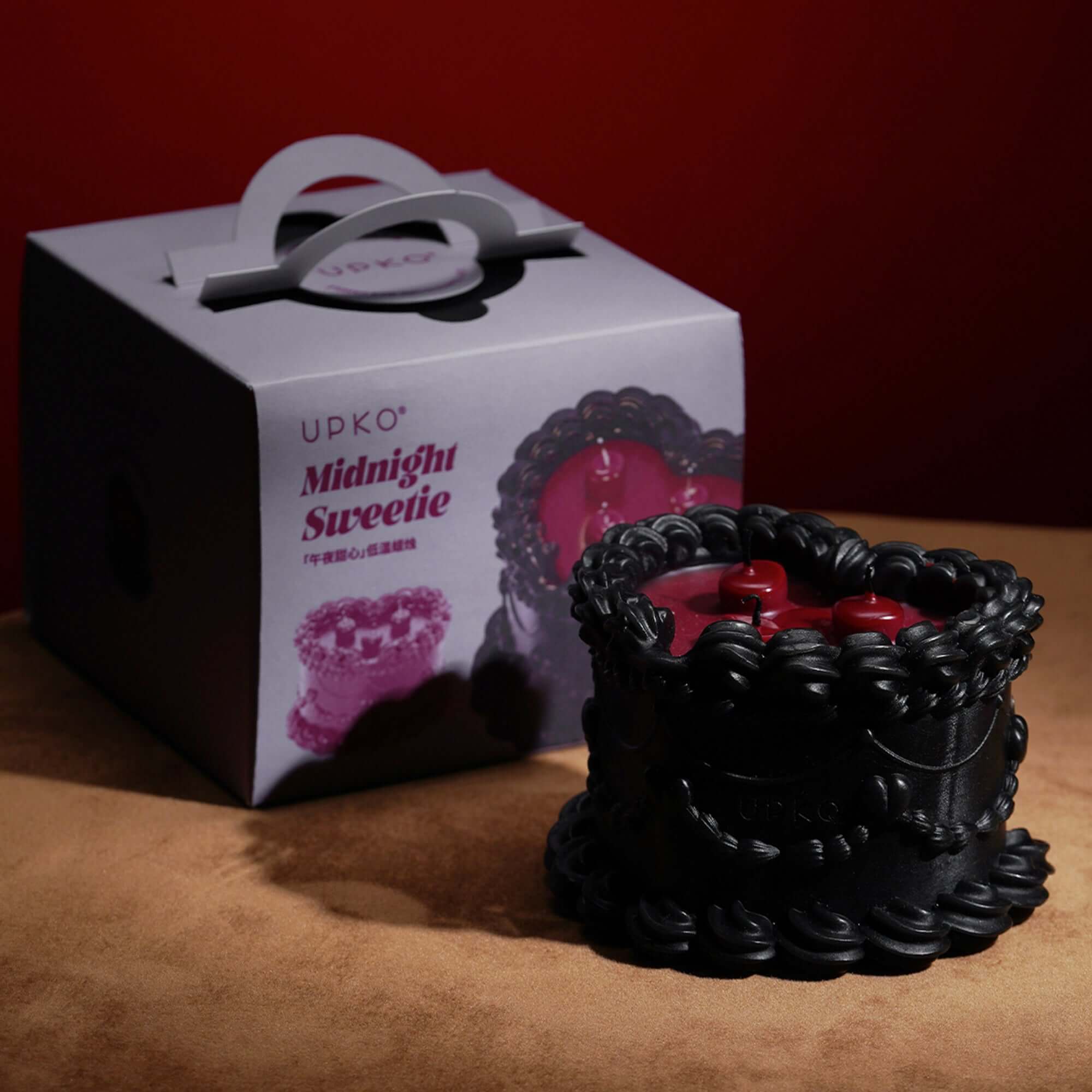 Midnight Sweetie low-temperature wax candle with cake design and black packaging, perfect for stylish play and decor.