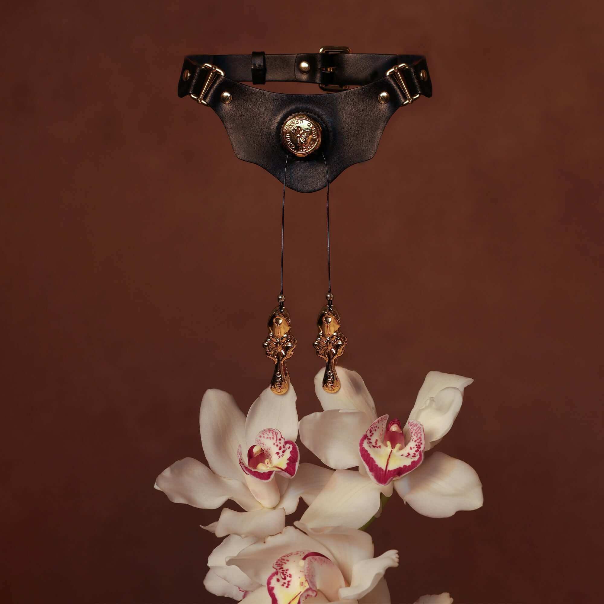 UPKO Mystic Bond Collection Collar with Pulling Nipple Clamps and orchids on a brown background.