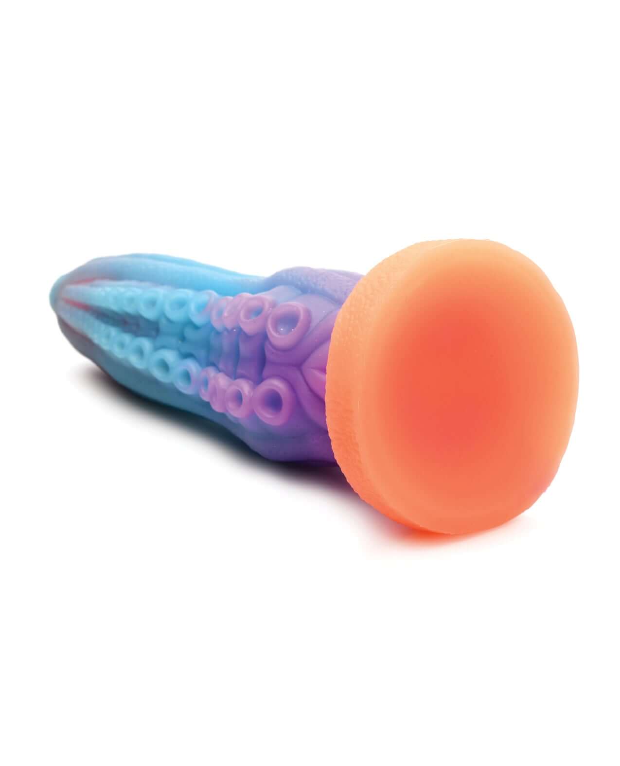 Glow-in-the-dark silicone dildo shaped like a tentacle, featuring blue, purple, and orange hues with textured suckers and calloused ridges.