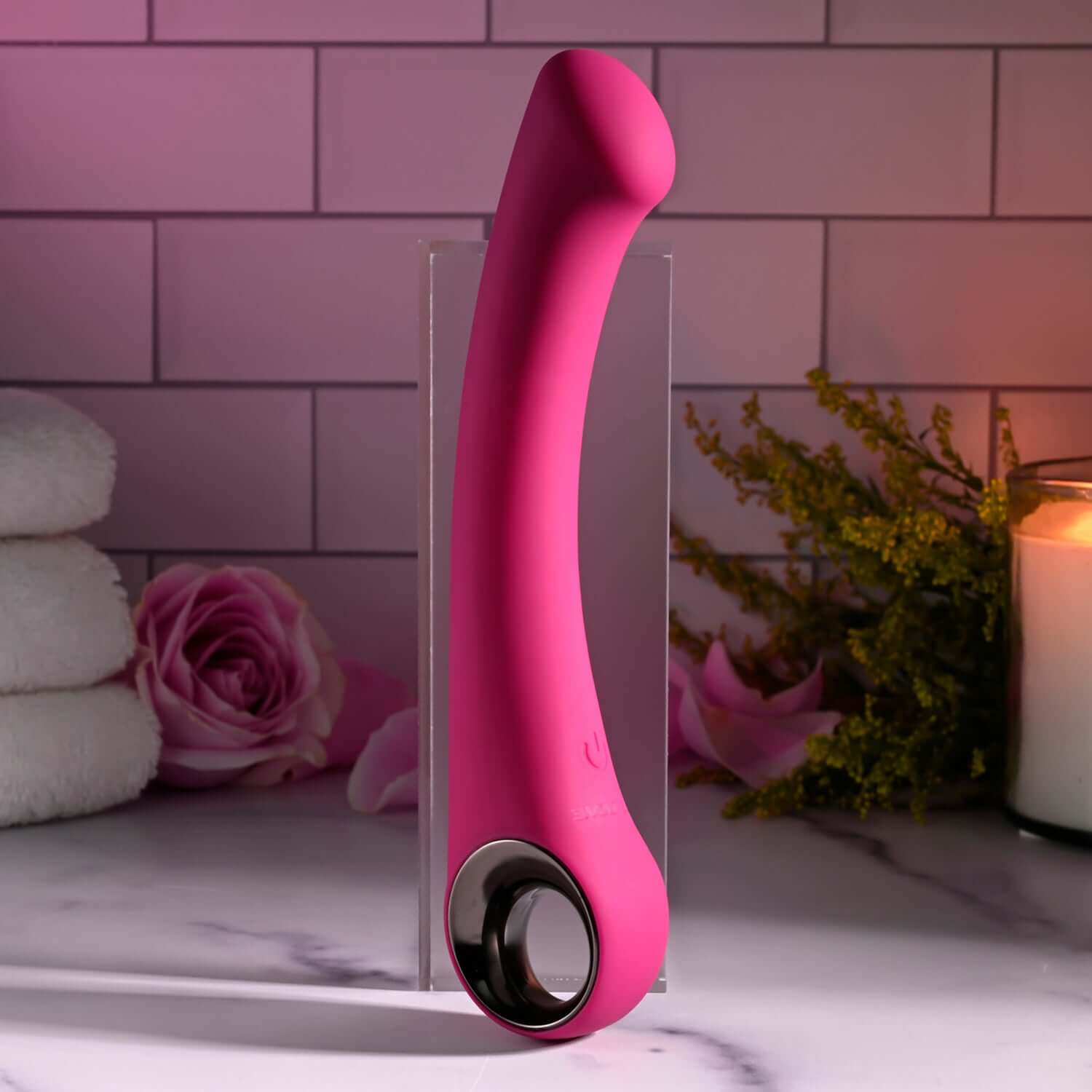 Pleasure Curve G-spot vibrator in pink with ergonomic design and chrome-finished handle, showcasing its elegant shape and texture.