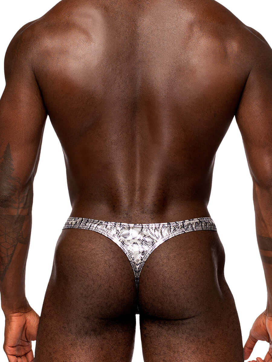 Male model wearing S’naked Criss Cross Thong in silver/black metallic snakeskin fabric, showcasing t-back design and low cut waist.