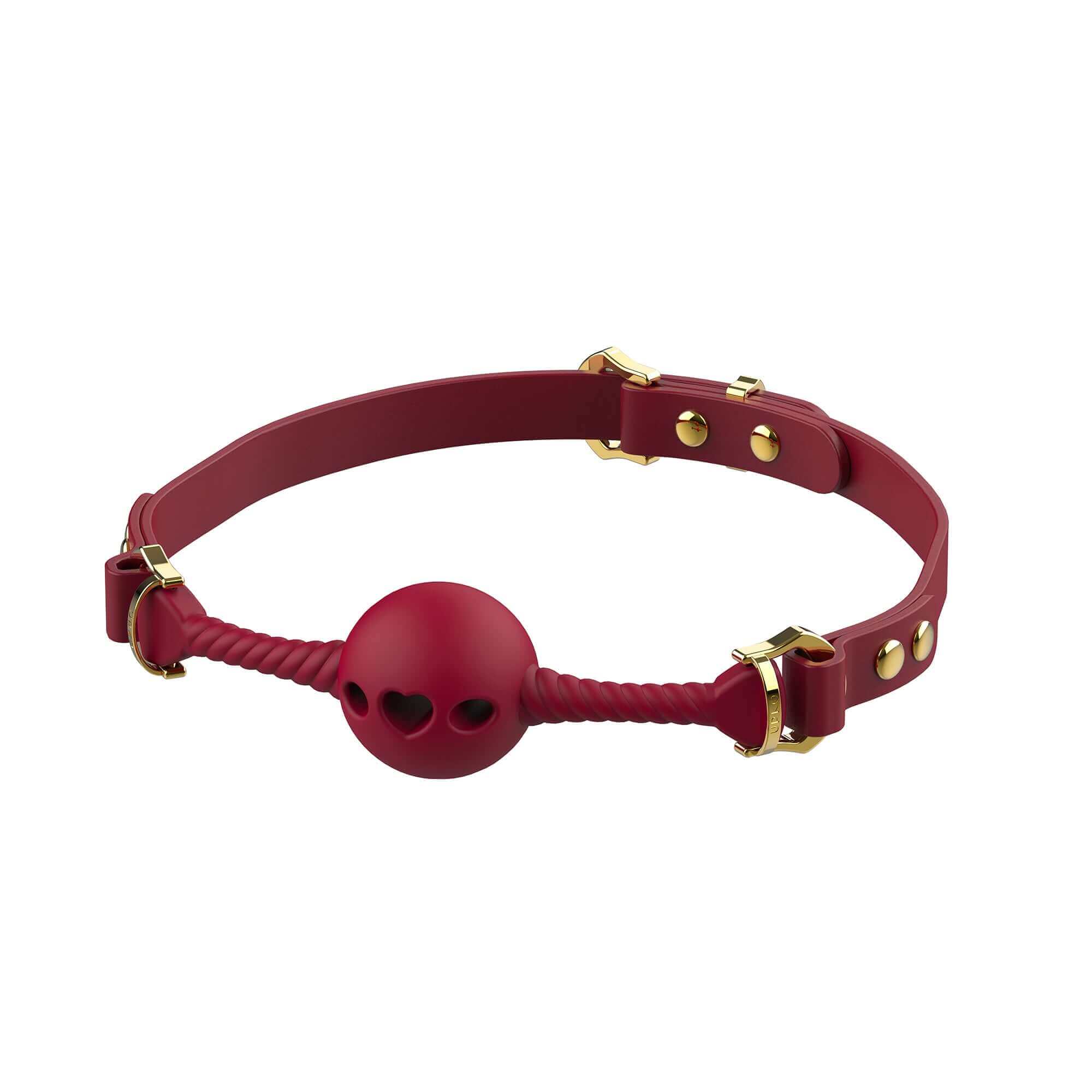 Red heart-shaped mouth gag with adjustable Italian leather strap and gold hardware accents for safe and comfortable oral play.