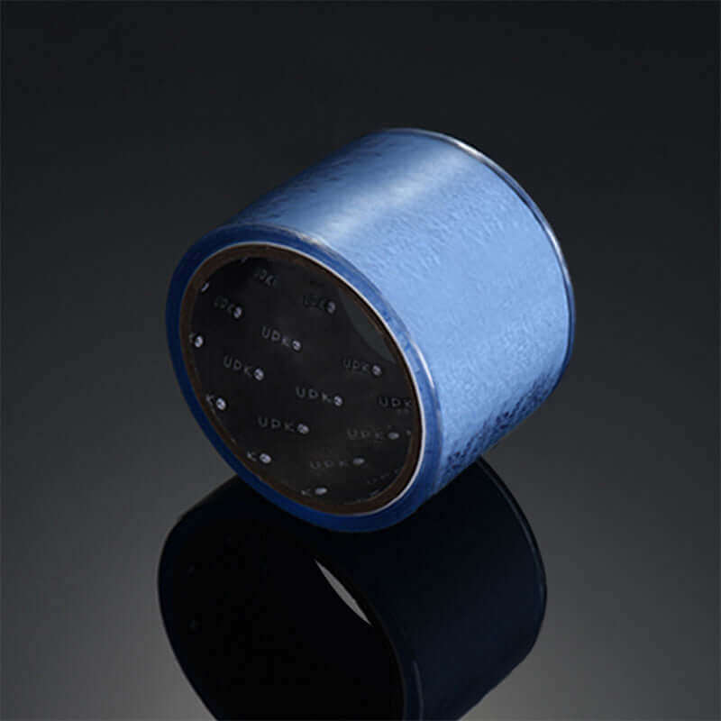 Blue UPKO standard static bondage tape roll on reflective surface, made of PVC, ideal for versatile bondage experiences.