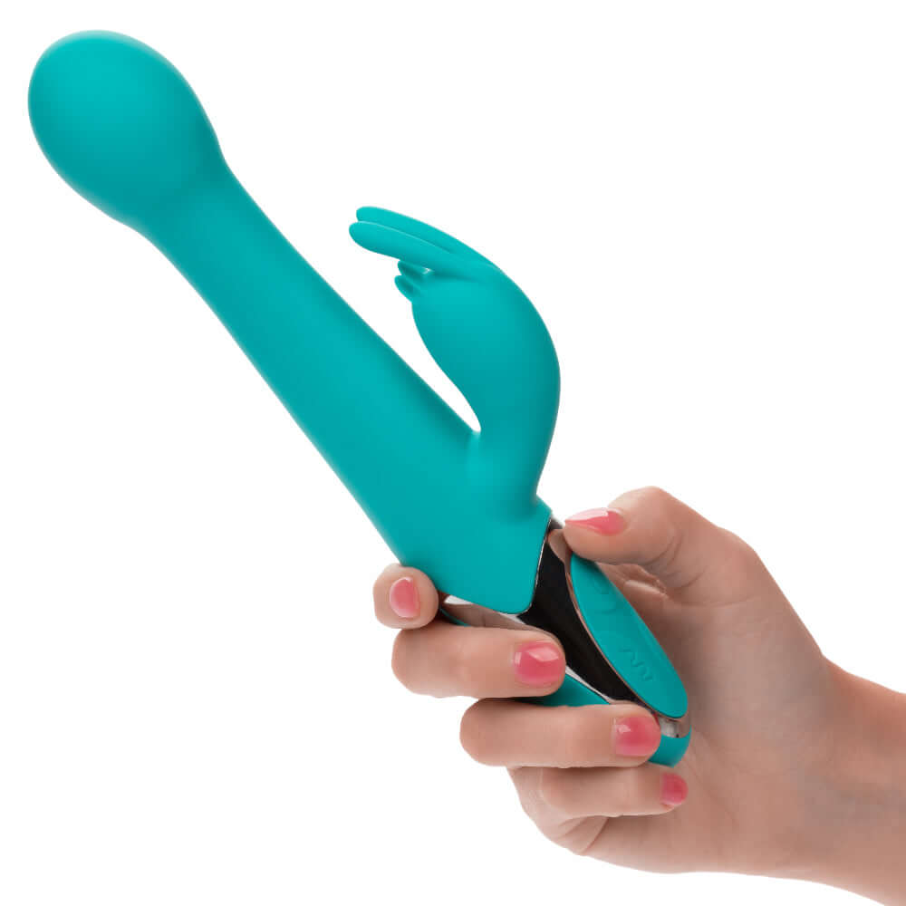 Enchanted Oscillate Massager - Turquoise dual stimulator with thrusting and rotating beads held in hand.