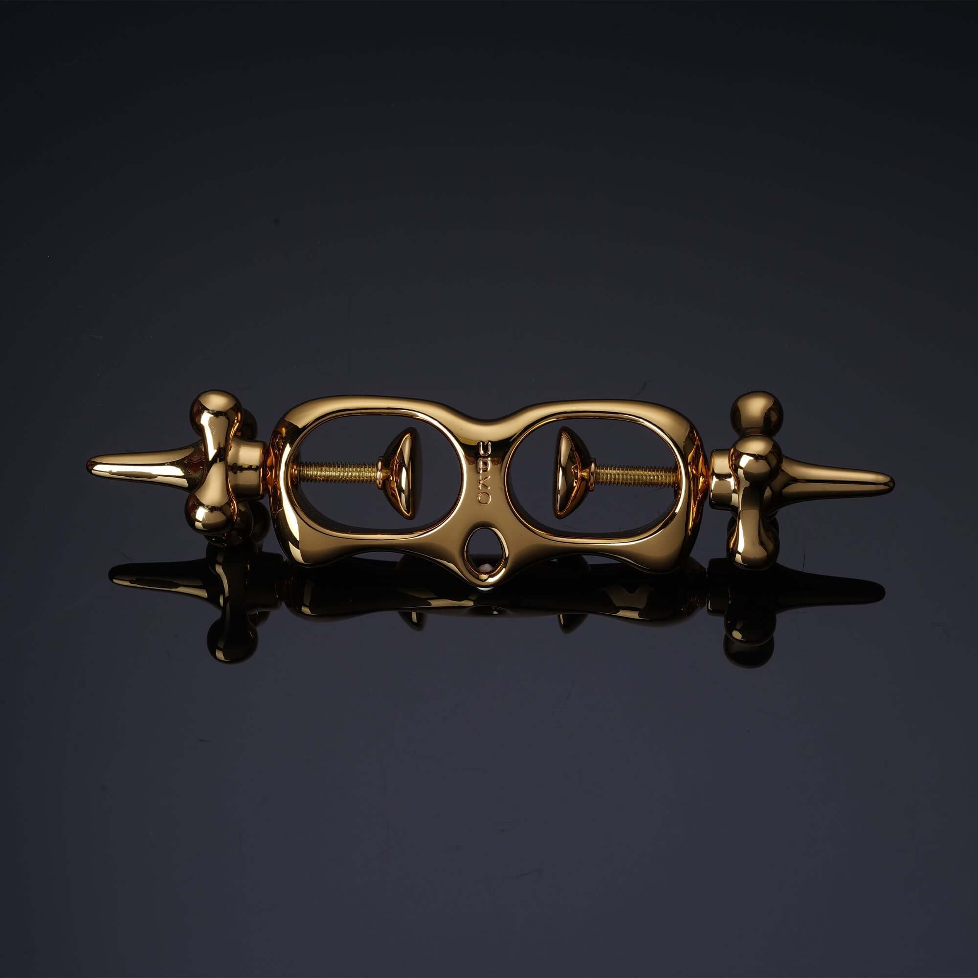 UPKO Thumb Metal Cuffs in sleek gold design, featuring a unique pull-string mechanism for secure restraint in discipline play.