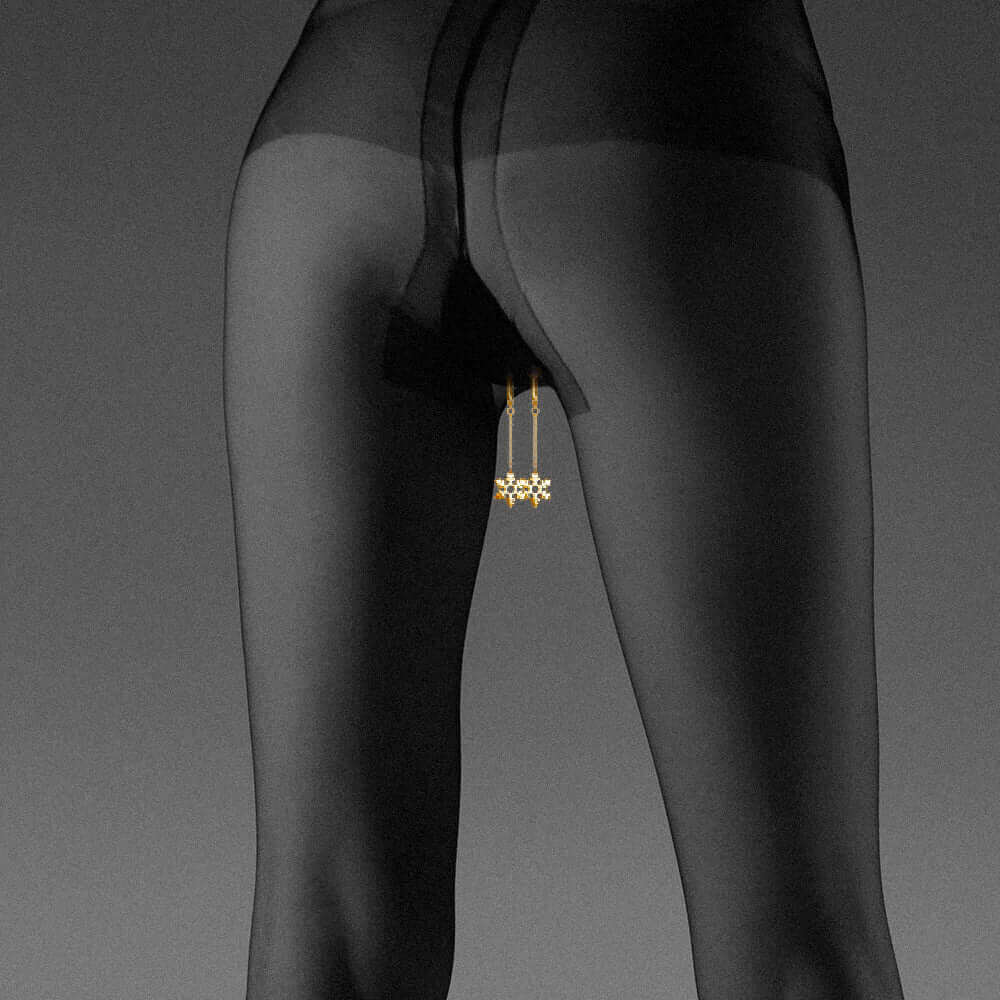 Non-pierced snowflake clitoral jewelry showcased on a model wearing sheer tights, highlighting elegance and intimacy.