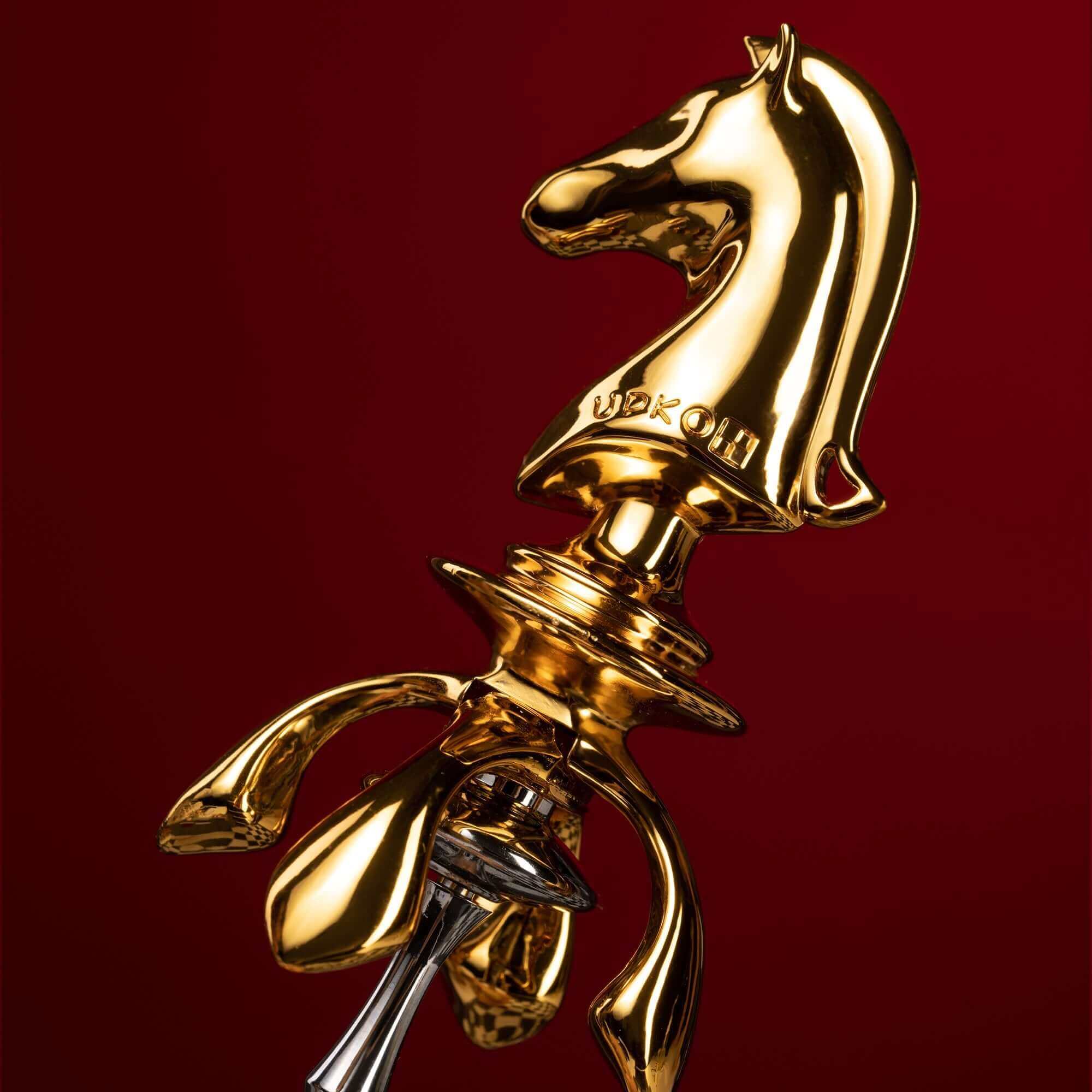 Gold knight-shaped urethral sound from "The Chess" collection, featuring intricate design for erotic pleasure.