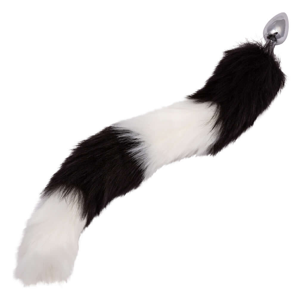 Black and white Running Wild Tail Anal Plug with long luxurious fur and smooth metallic probe for exotic pleasure and enhanced stimulation.