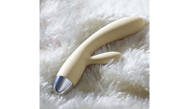 Alice Rabbit Vibrator in Khaki by Svakom on fluffy white surface, showcasing its sleek design and silicone material.