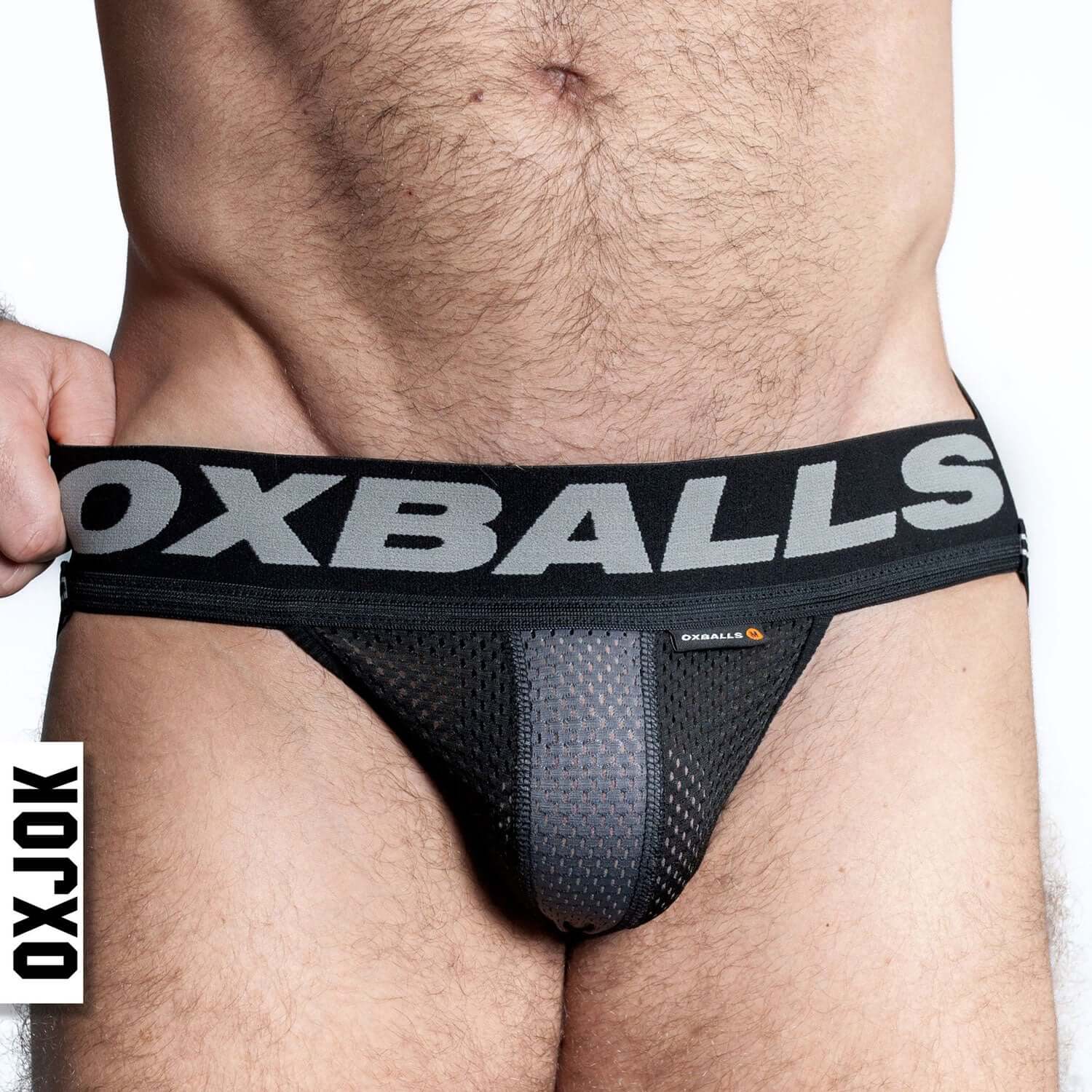 Man wearing Oxballs Airmesh Upthrust Slider-Strap Jock Tar Black Small with tri-fold pouch and bold waistband.