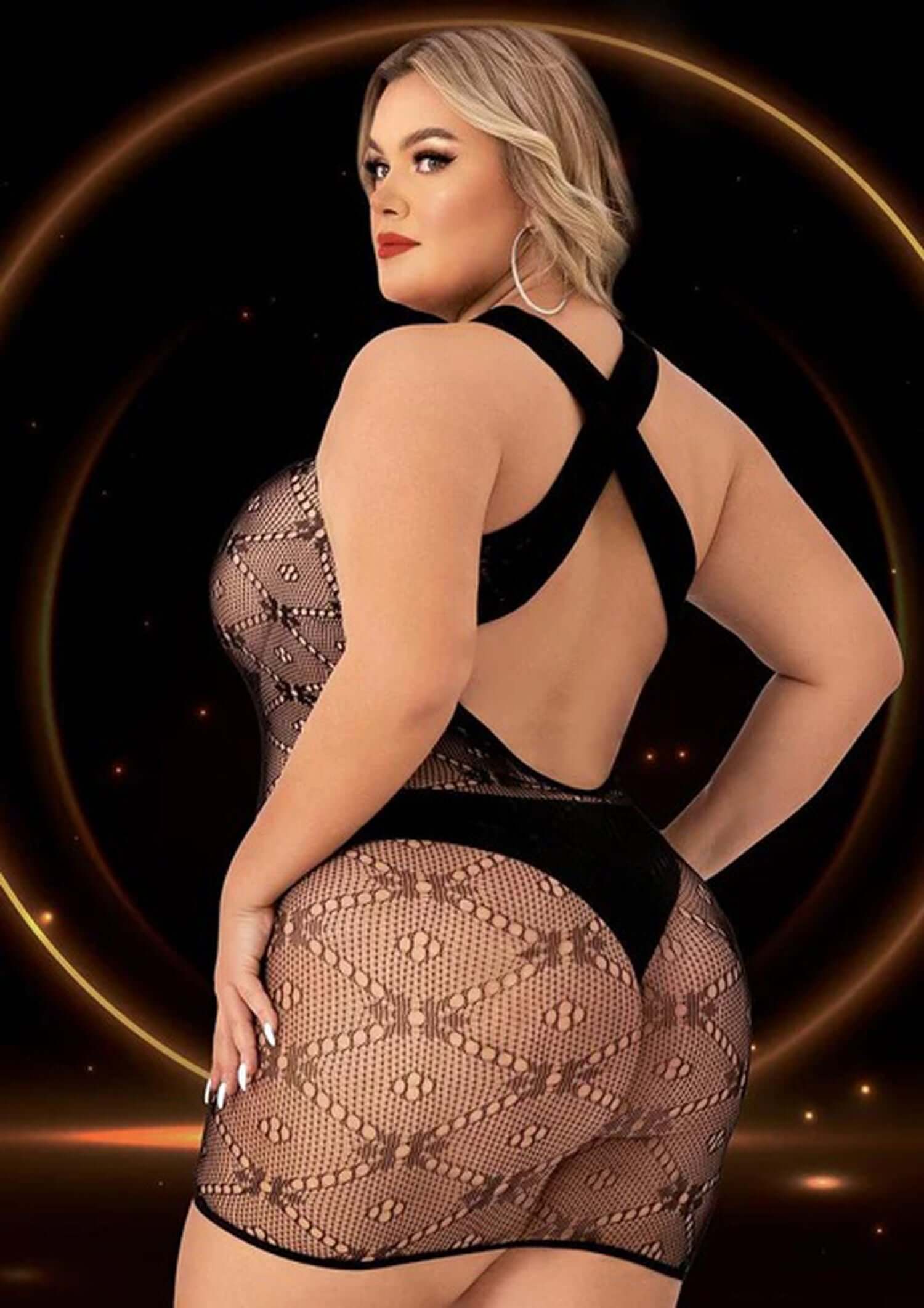 Plus-size model showcasing a seductive black halter top mini dress with cutouts and figure-hugging design.