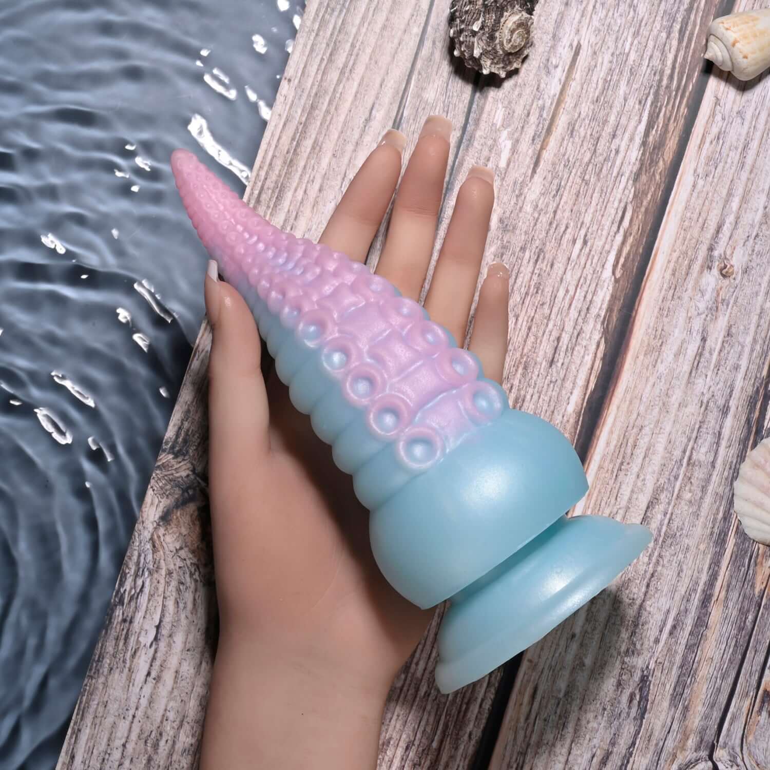 Stuck on You Vibrating Dildo, multicolor silicone design, showcasing flexible tentacle and suction cup base on wooden surface.