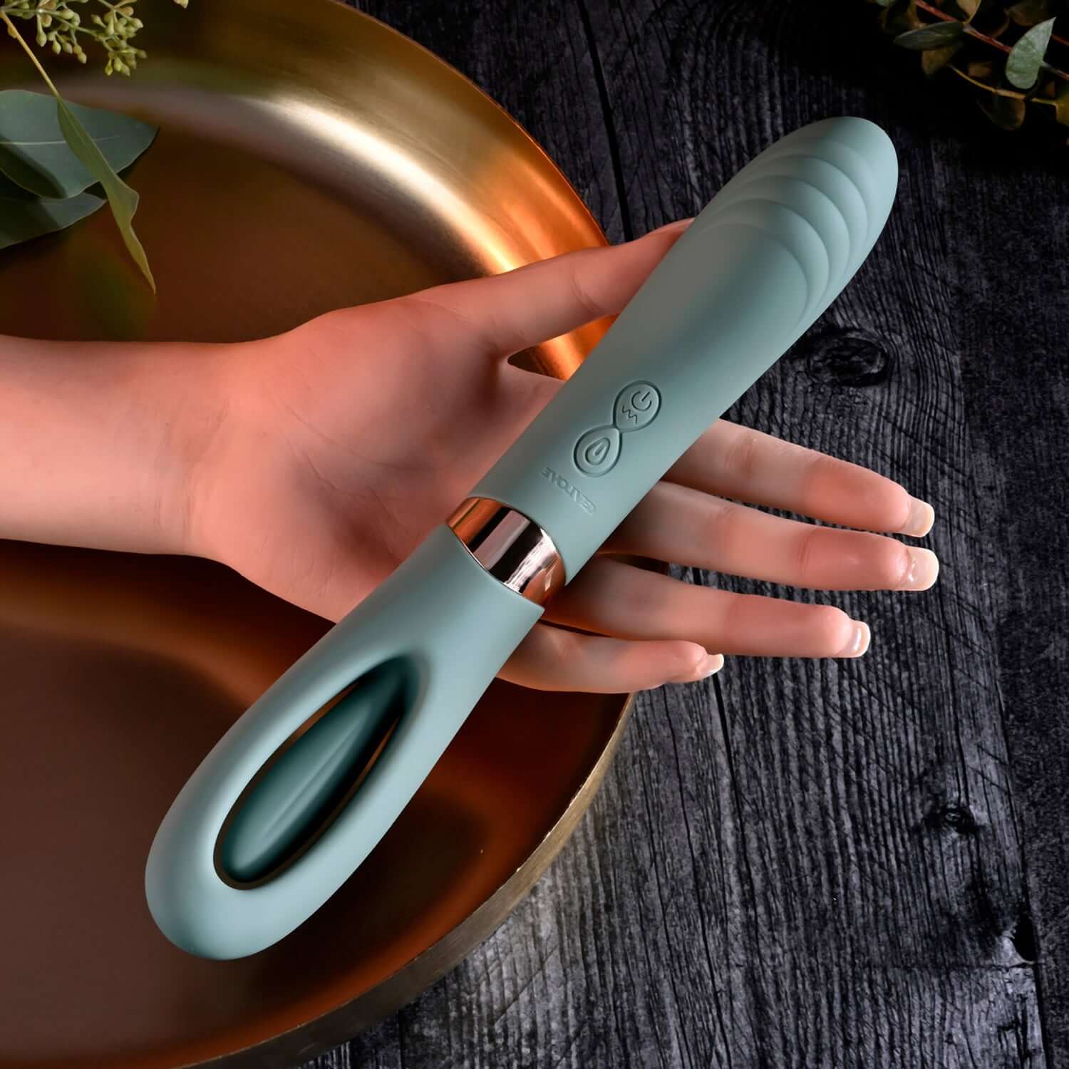 Chic Chick Flick Tongue Mint Vibrator held in hand, showcasing its curved design and controls for stimulating pleasure.