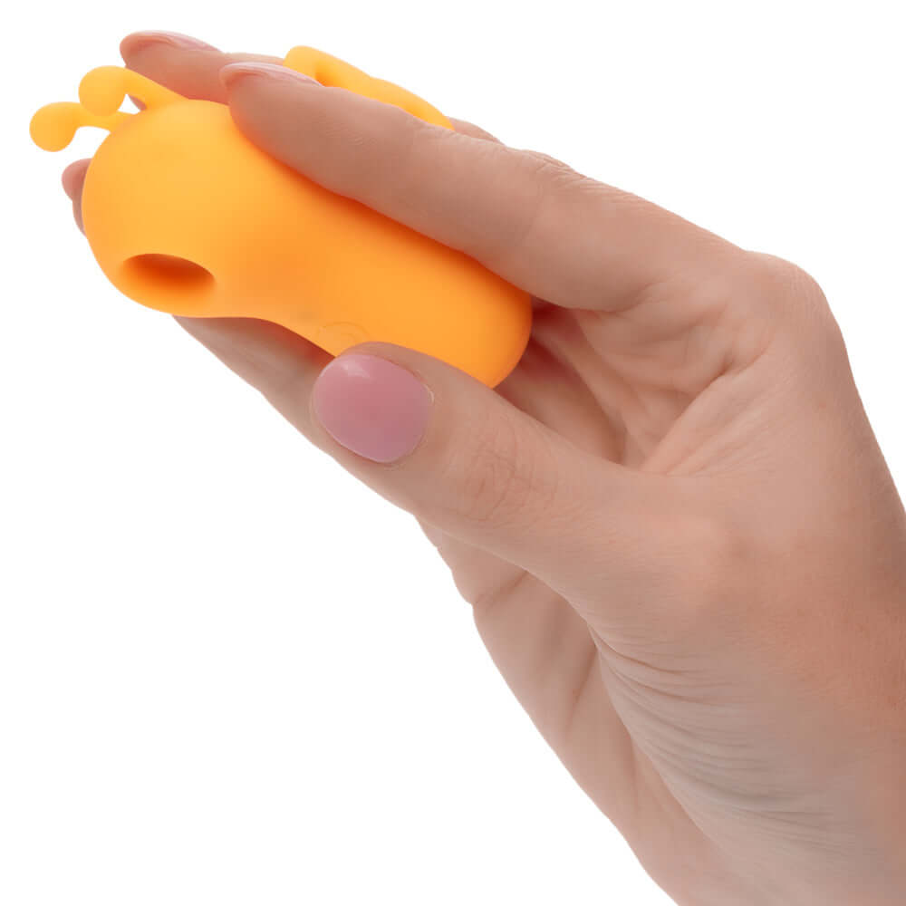 Hand holding Neon Vibes The Buzzing Vibe in orange color, showcasing its ergonomic design and tantalizing antennae