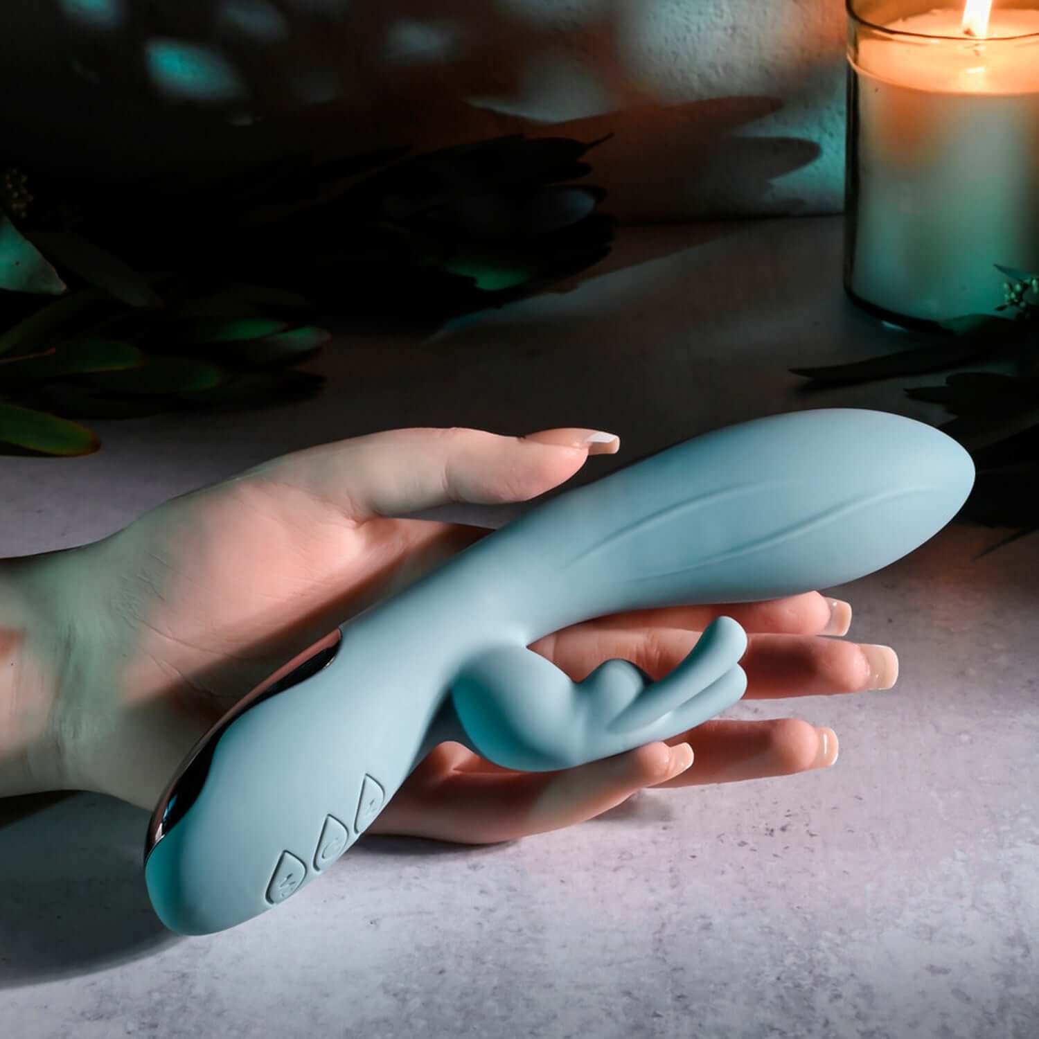 Blue Boss Bunny Rabbit Vibrator held in hand, showcasing its sleek silicone design and flexible long-eared shaft for stimulation.