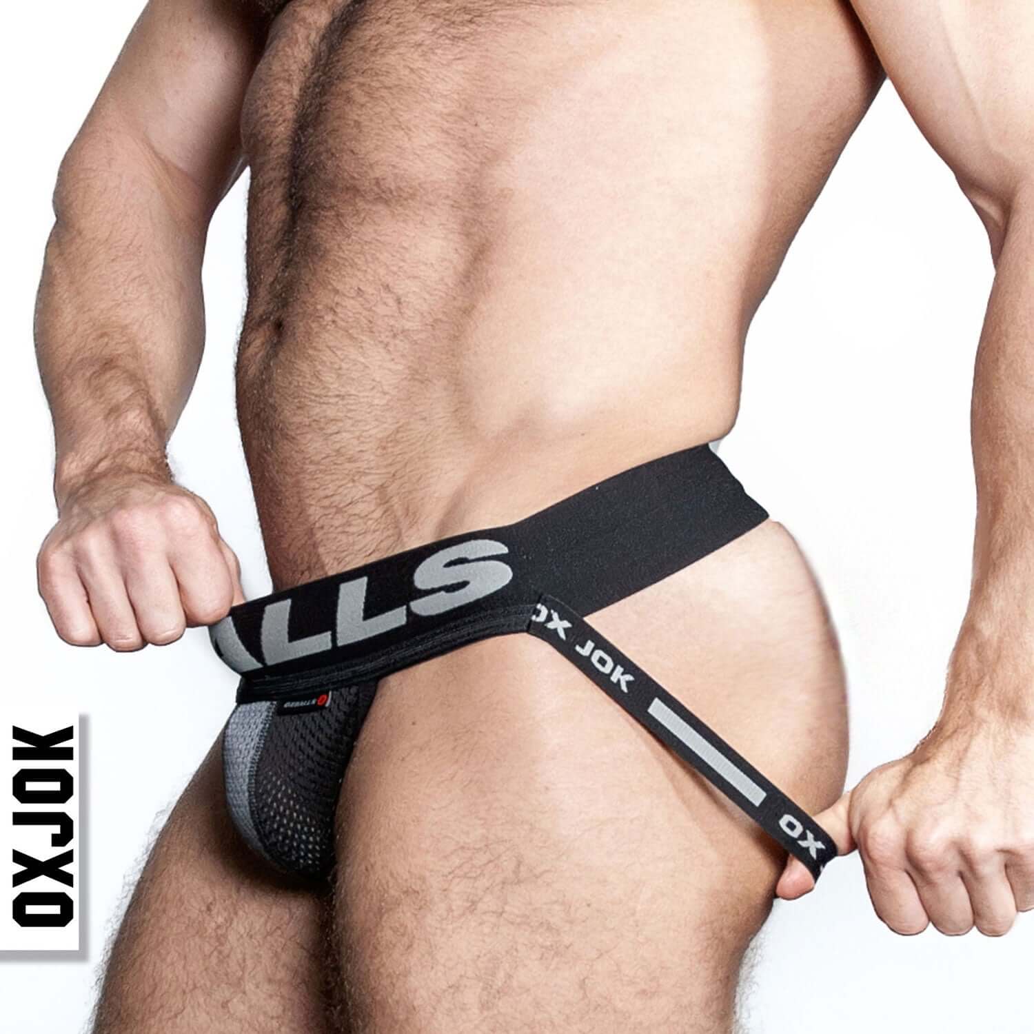 Man wearing Airmesh Upthrust Slider-Strap Jock Tar Black showcasing no-dig comfort tri-fold pouch and firm Oxballs waistband.