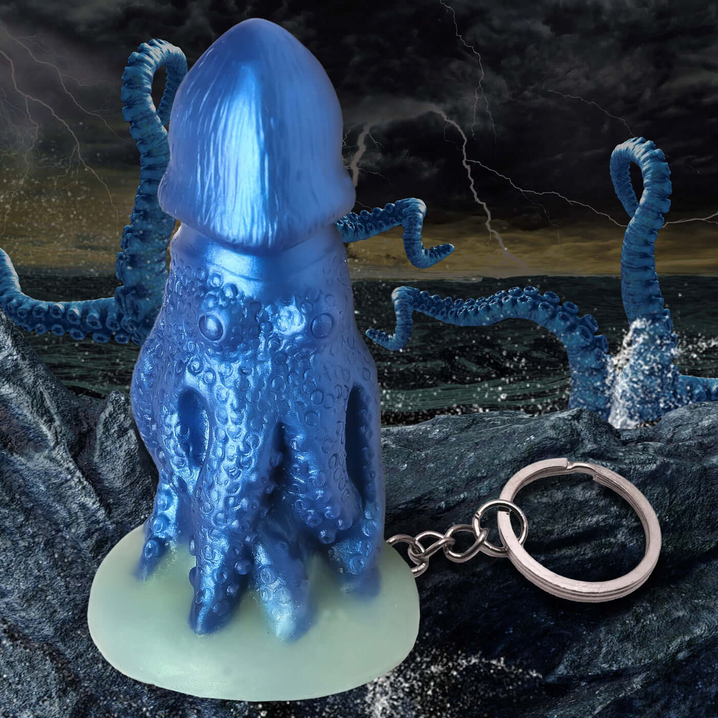 Blue Cocktopus Keychain featuring a thick-headed octopus creature in a stormy ocean background.