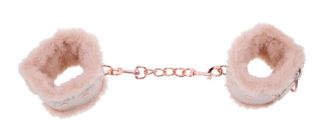 Peaches 'N Creame pink faux fur handcuffs with rose gold chain for playful pleasure and intimate moments.