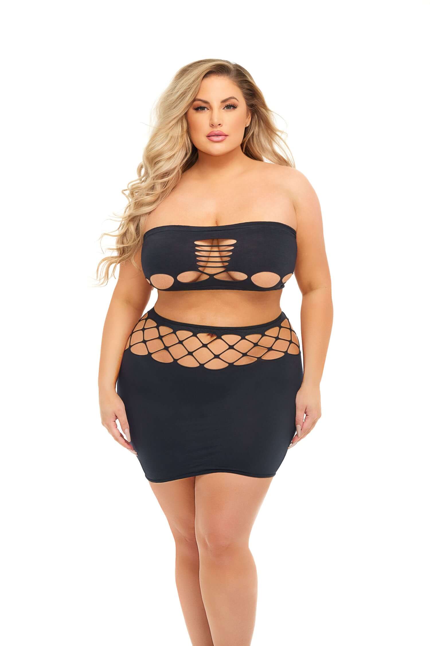 Plus size model wearing Net Worth 2pc Bandeau Set in black showing front details of bandeau and skirt with cut-out design.