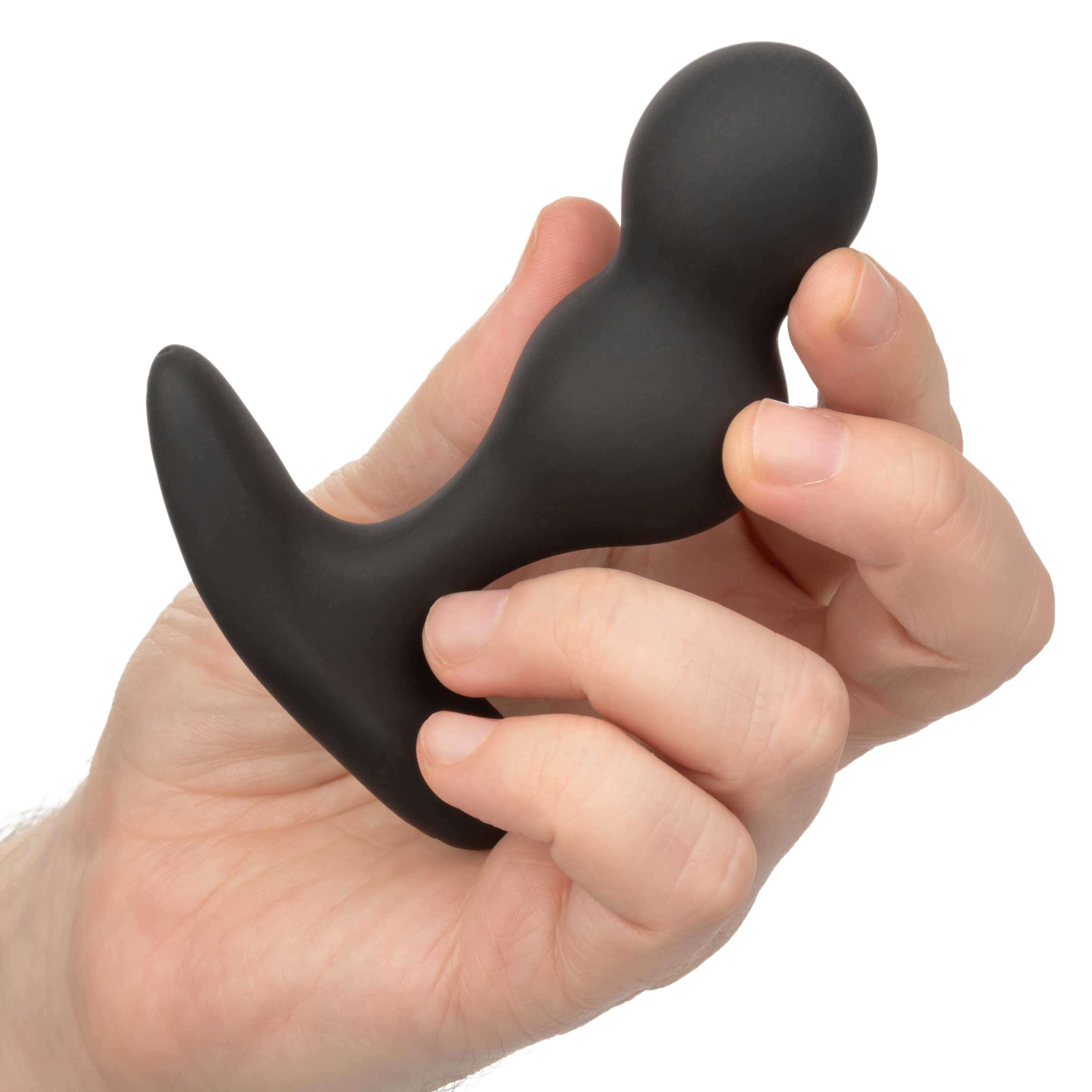 Person holding Colt Rechargeable Anal-T, a black anal probe with a curved base for powerful vibration and personalized pleasure